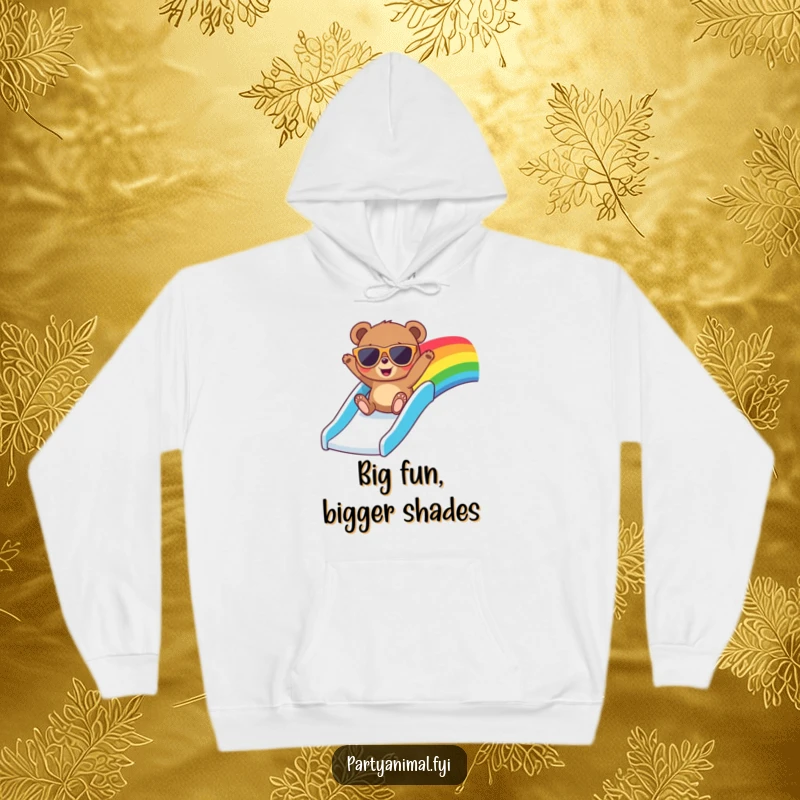 Funny hoodie featuring a bear in large sunglasses, gleefully riding a rainbow slide with an expression of pure happiness and freedom.