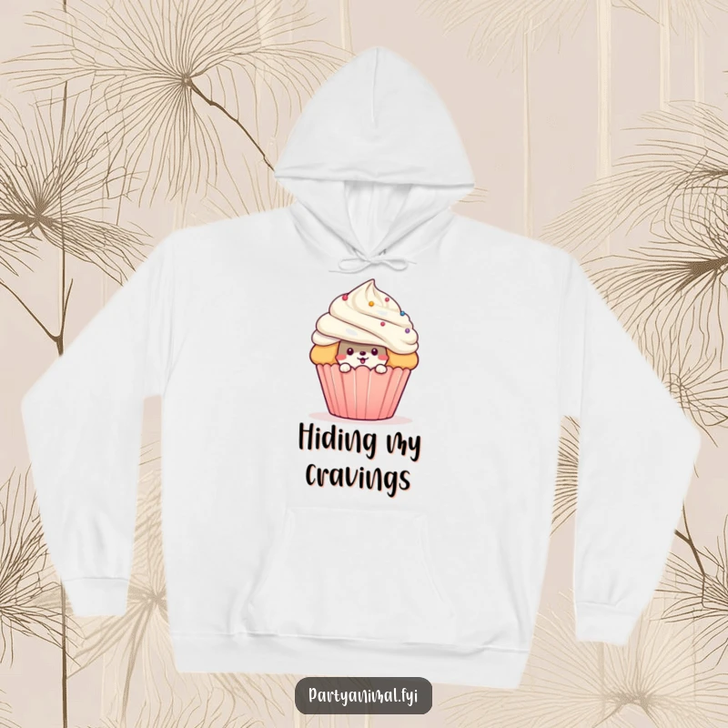 Comfortable funny hoodie with a mischievous animal character peeking from behind a giant cupcake, offering warmth and sweet surprise.