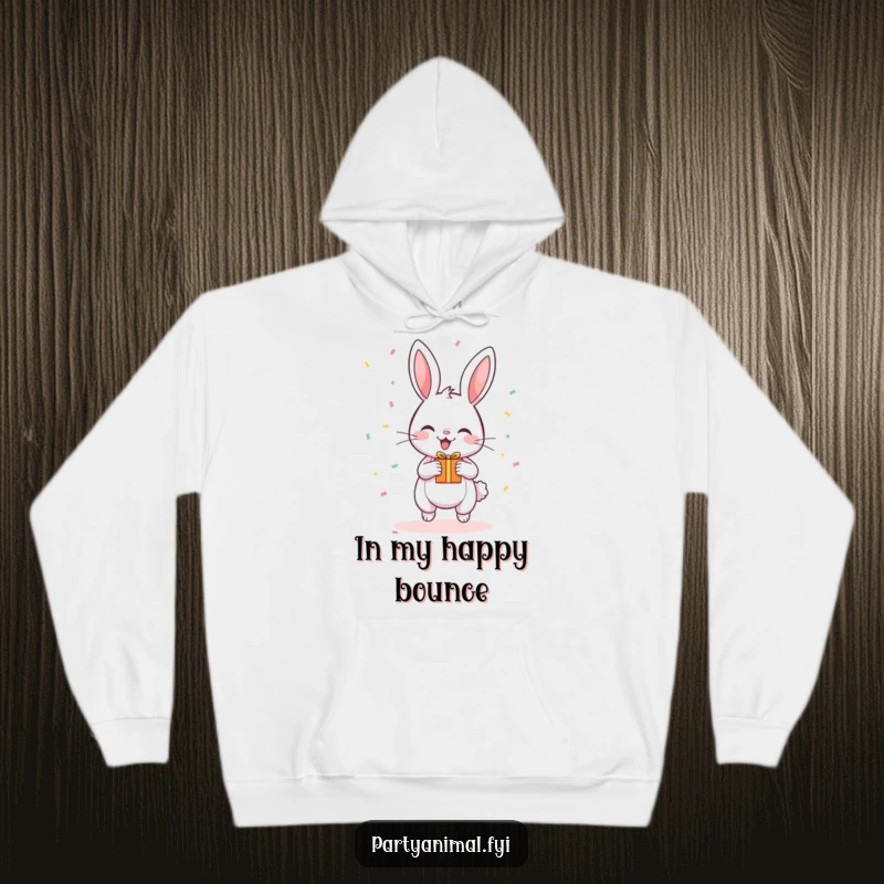 Funny Hoodie depicting a happy, bouncing bunny surrounded by confetti and holding a small gift.