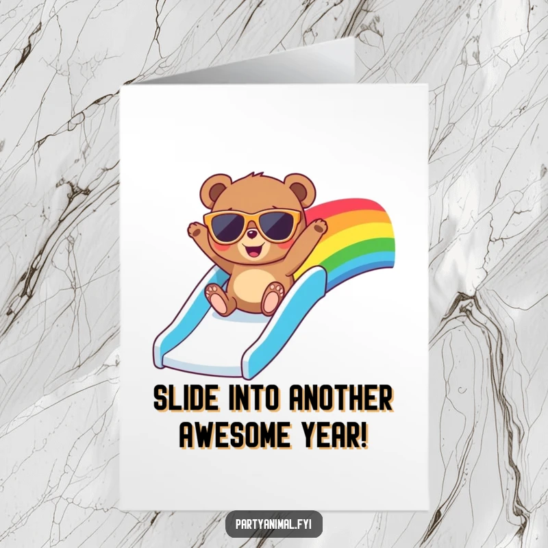 Funny free printable birthday card showing a bear in sunglasses joyfully sliding down a vibrant rainbow slide, celebrating with pure glee.