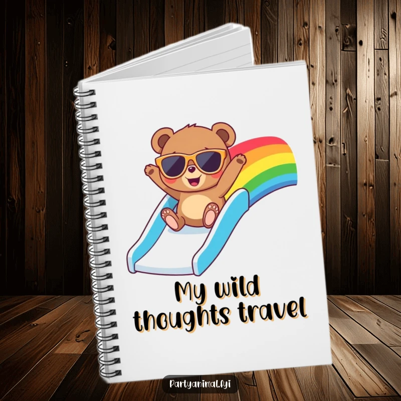 Funny notebook cover featuring a bear in cool oversized sunglasses, gleefully sliding down a vibrant rainbow slide, ready for notes.