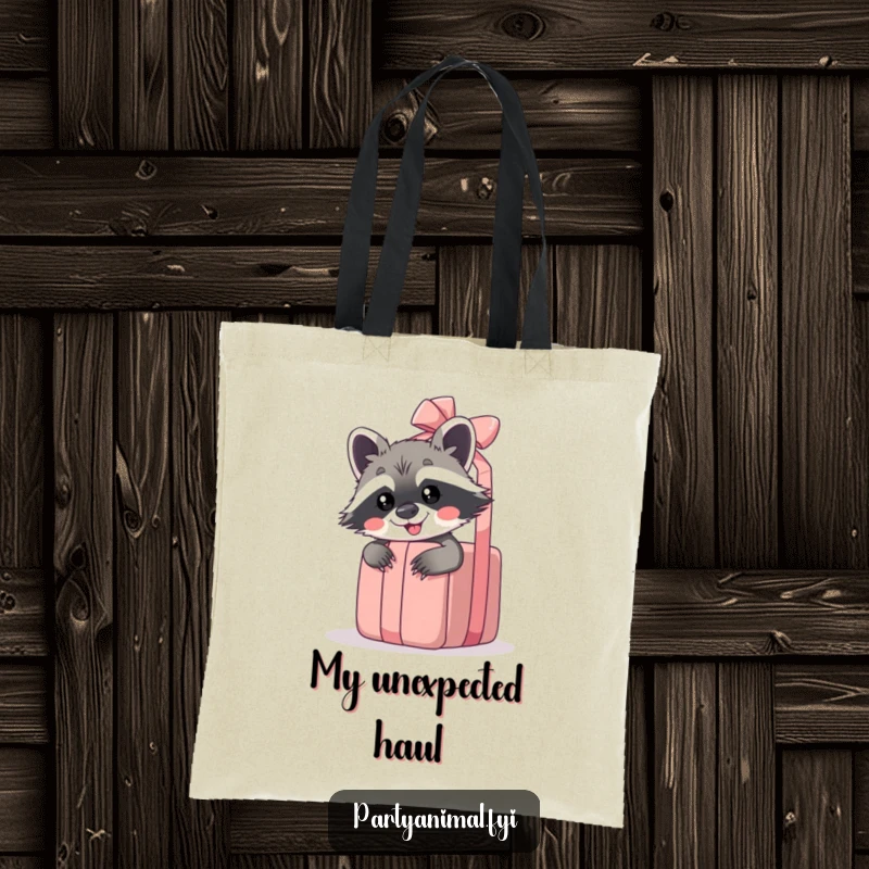Funny raccoon tote bag with a giggling raccoon peeking from behind a giant unwrapped gift, ideal for carrying essentials.